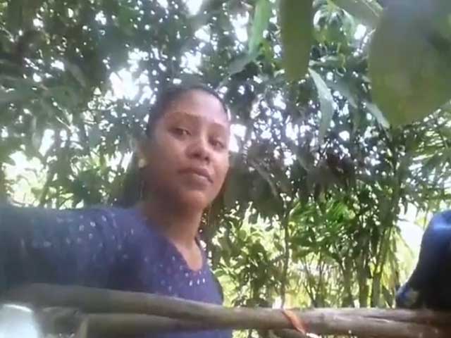 Village girl changing dress ouitdoors after bath